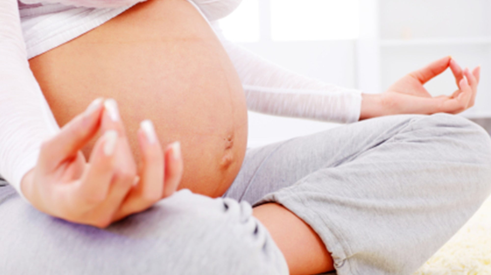 Pregnant Yoga Student, in Sukhasana the easy pose