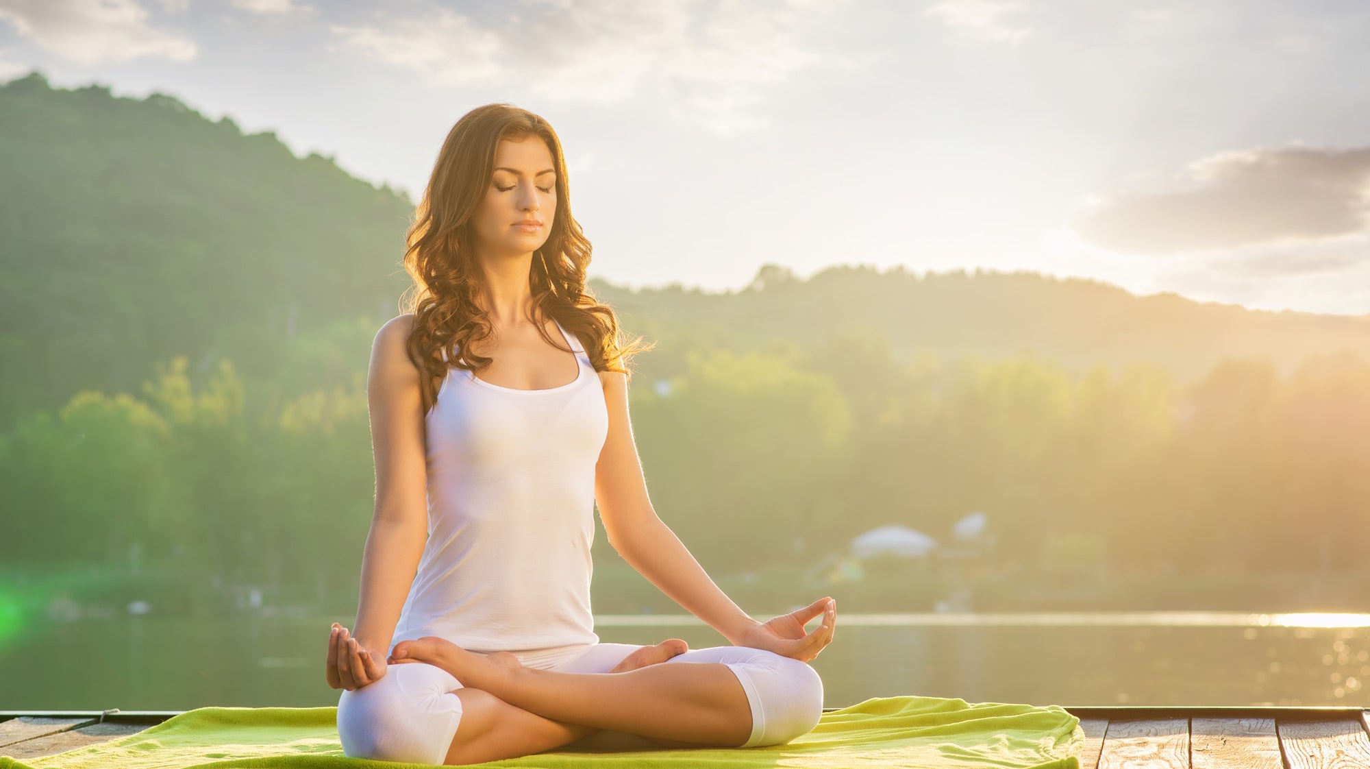 Young lady practicing sukhasana yoga posture