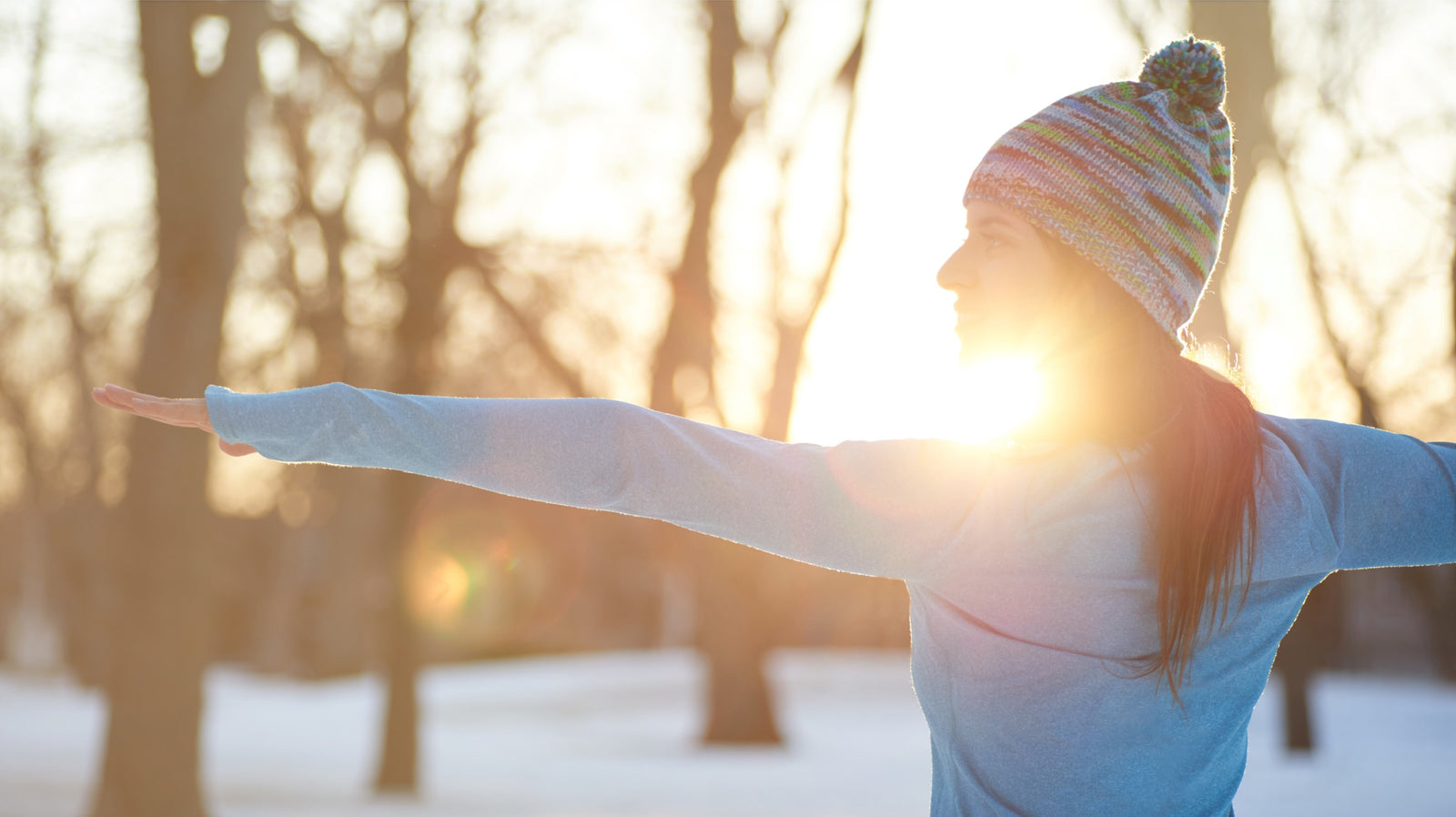 Lady practicing yoga in the snow