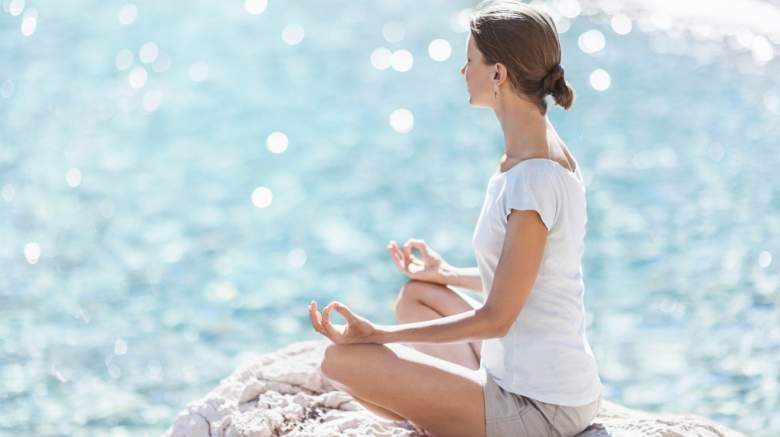 Lady in yoga posture sukhasana - the easy pose