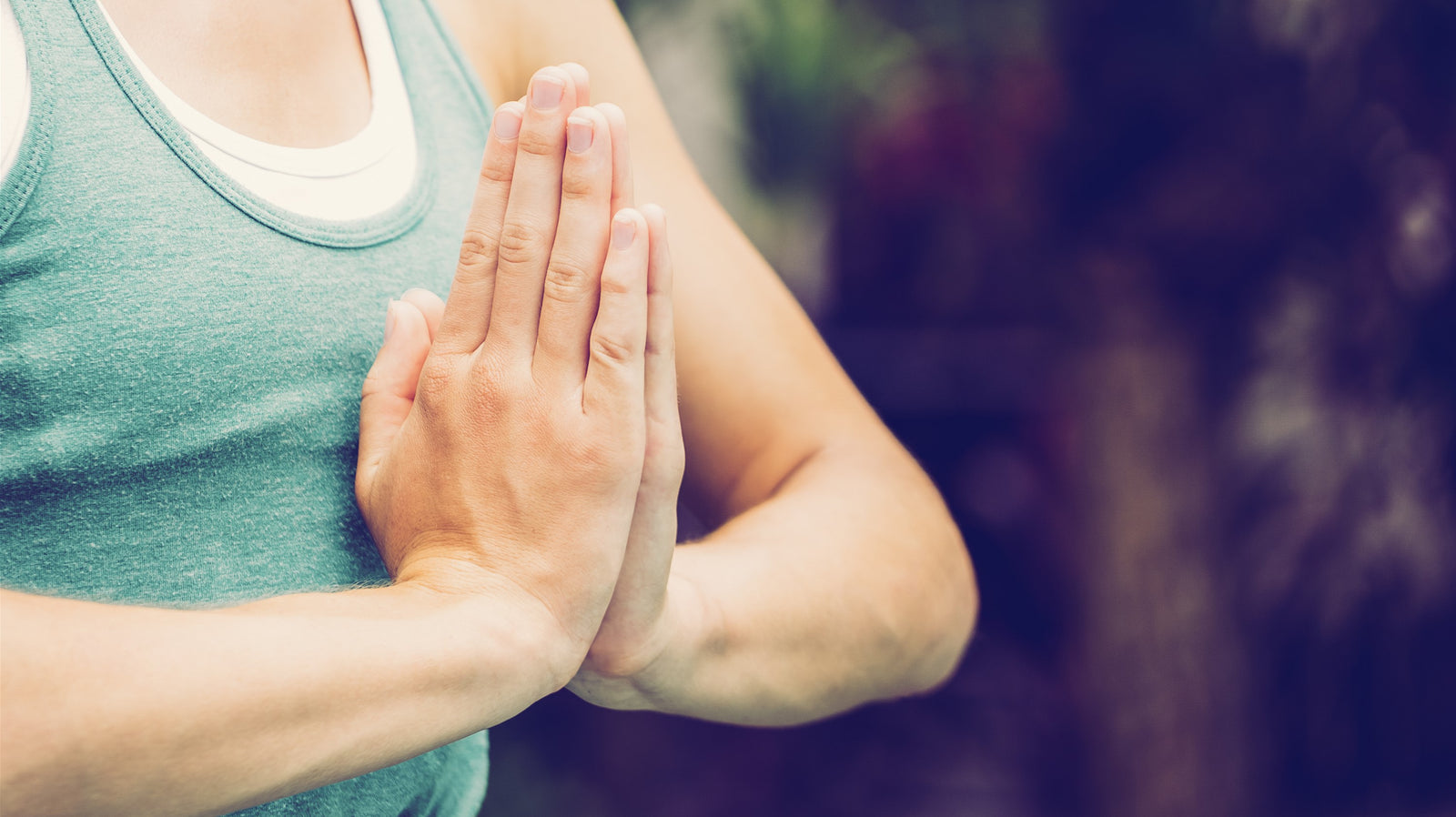 Lady with hands in a prayer position, Namaste.