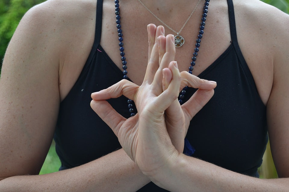Lady performing yogic hand gesture