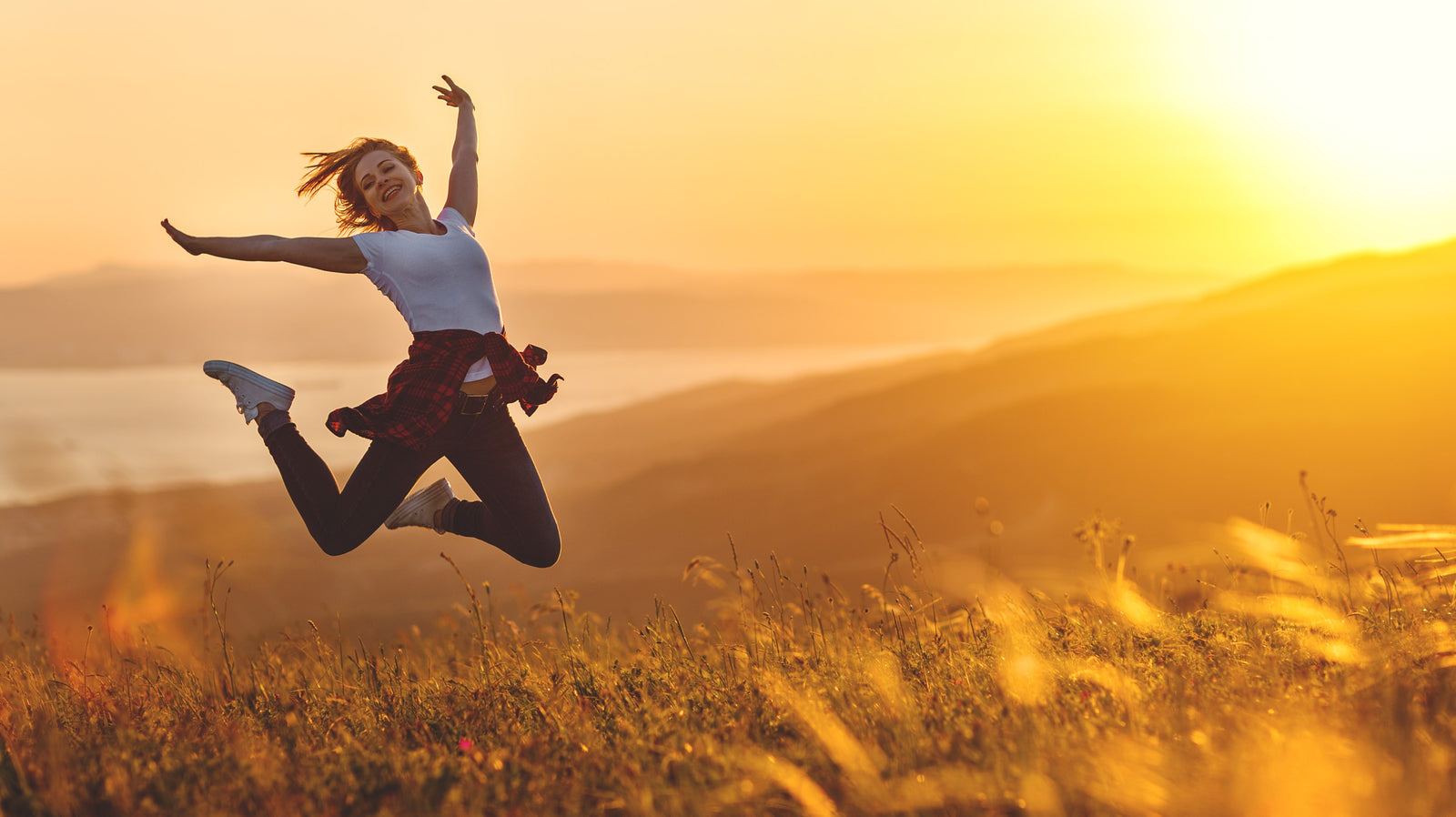 Lady jumping at sunset