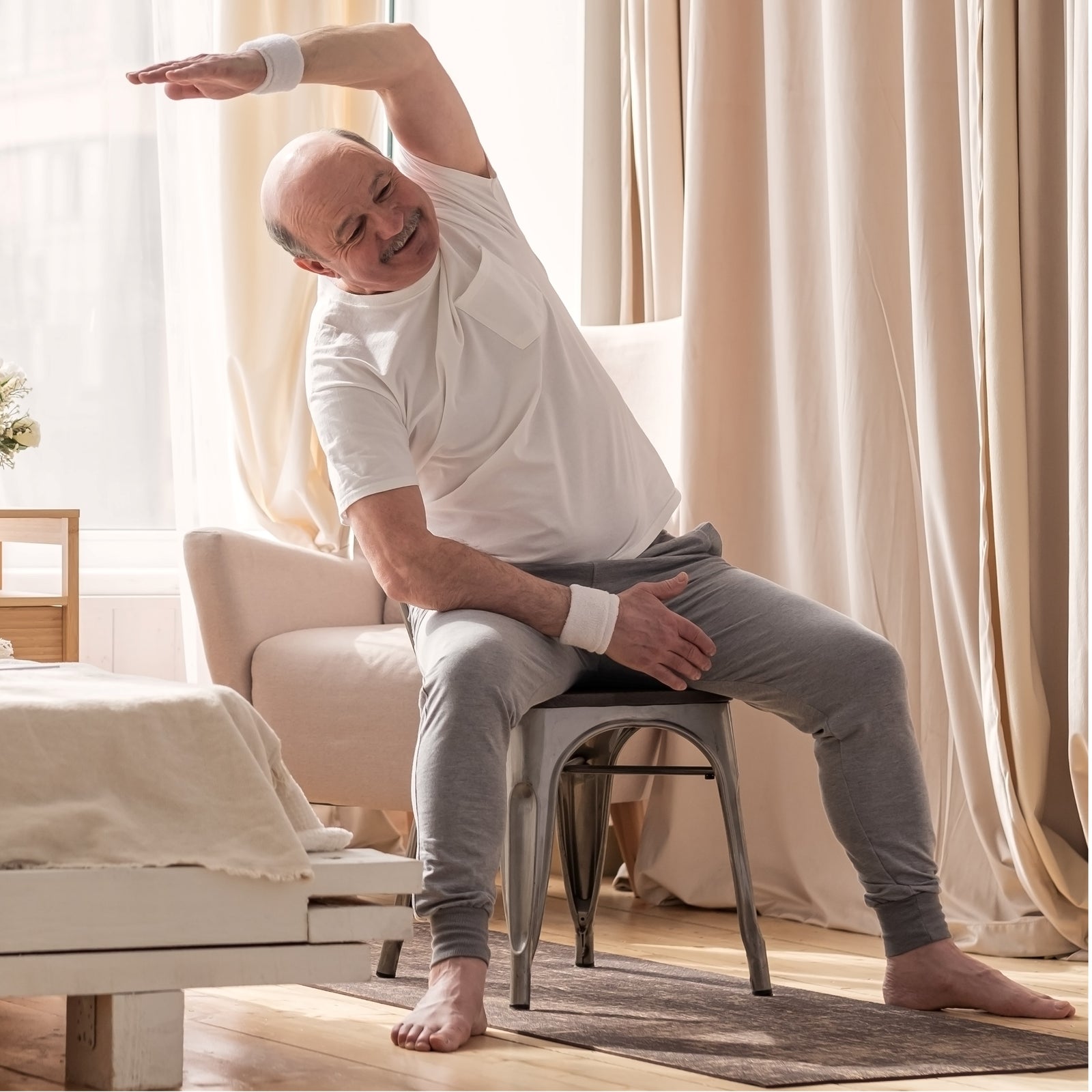 Man practicing chair yoga at home
