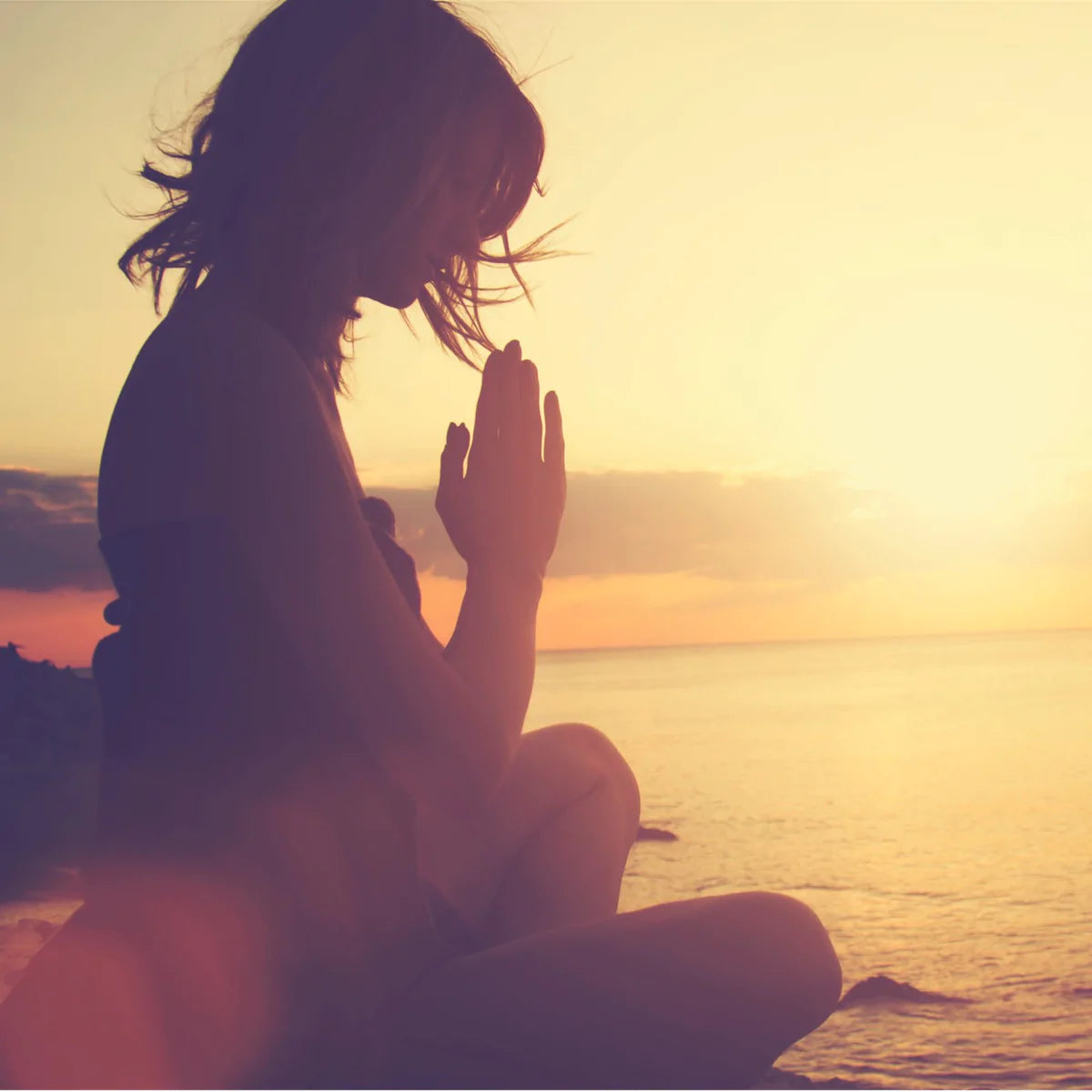 Lady practicing Yoga at Sunset