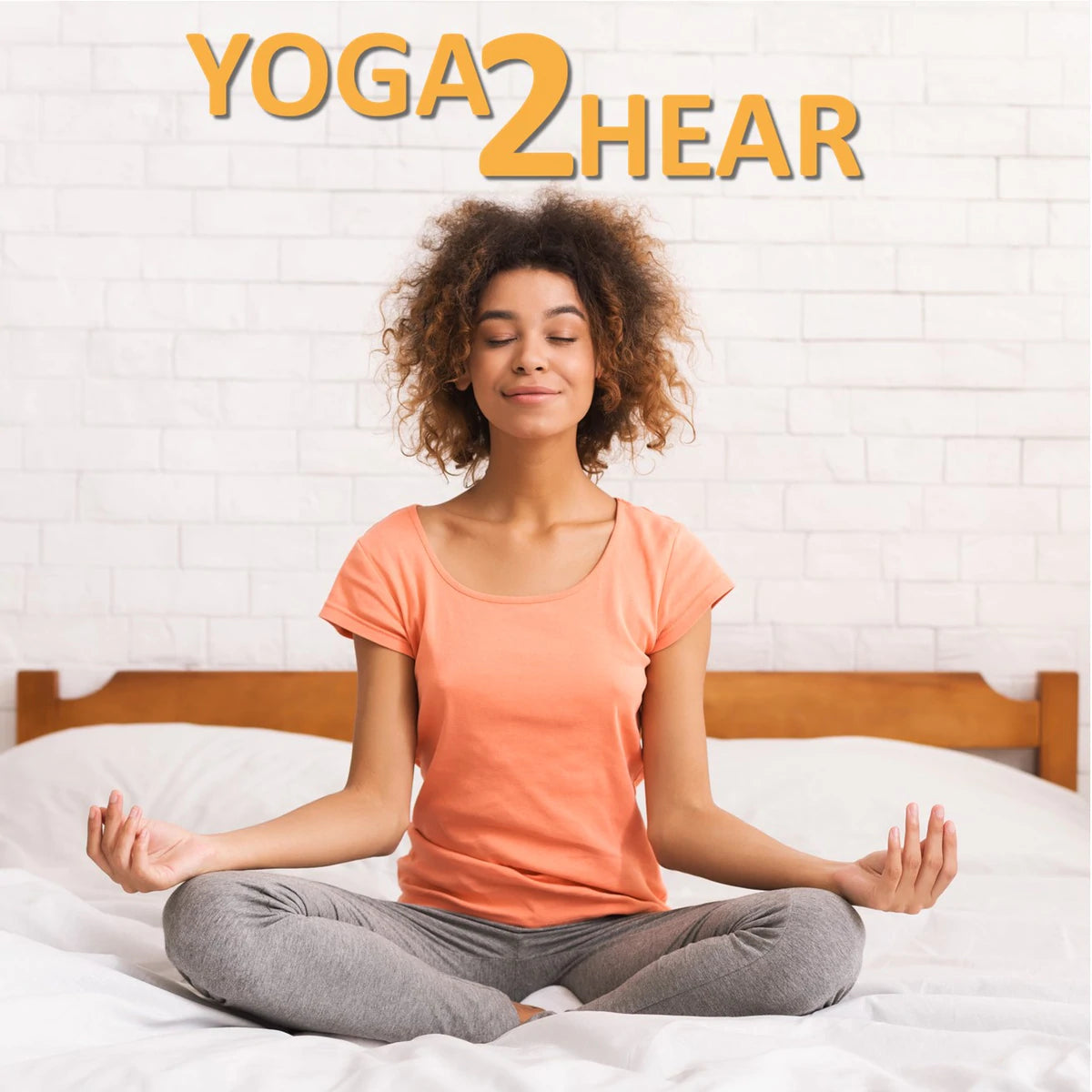 Lady sitting on her bed in the yoga posture sukhasana, the easy pose