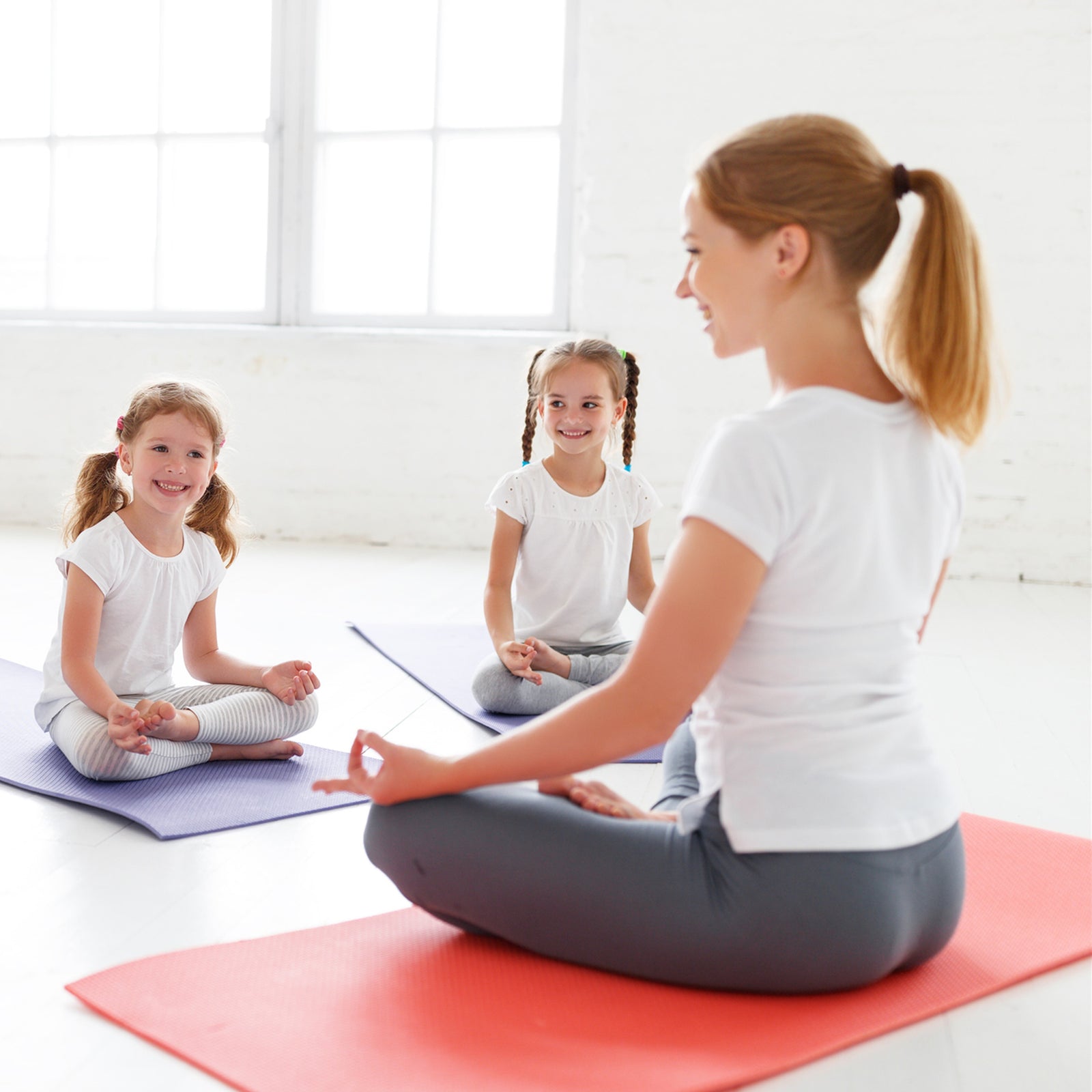 Yoga teacher, instructing children